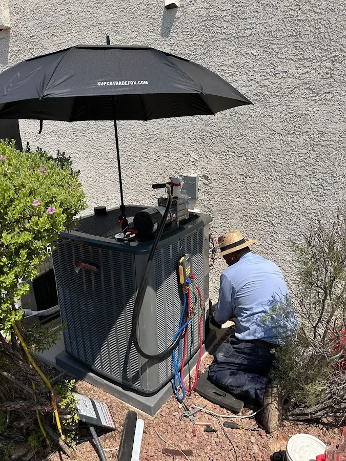 HVAC technician performing outdoor AC maintenance in Franklin Park