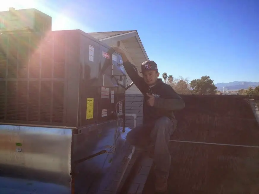 HVAC technician performing Boiler Repair on a rooftop unit in Franklin Park